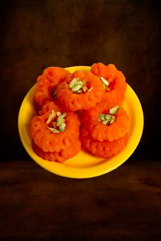 Jangiri sweets on a yellow plate