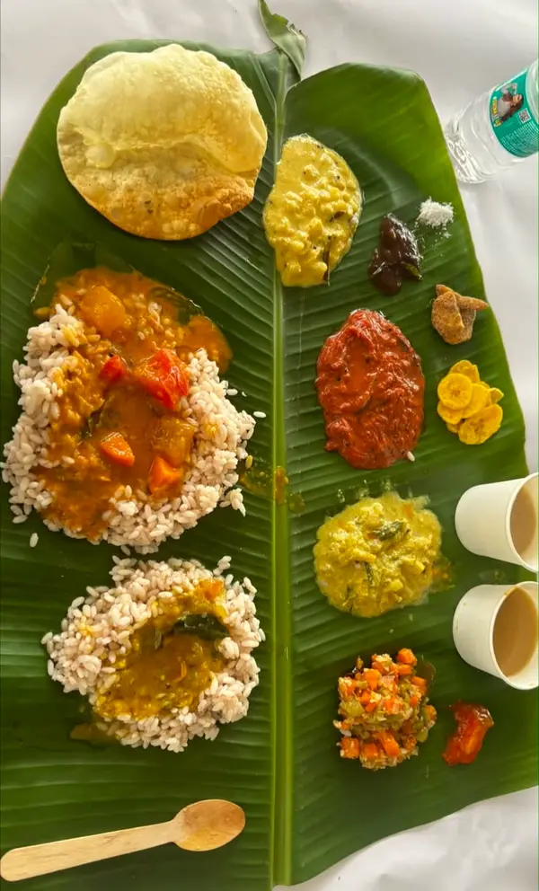 Banana-leaf meal with poori, rice and curries