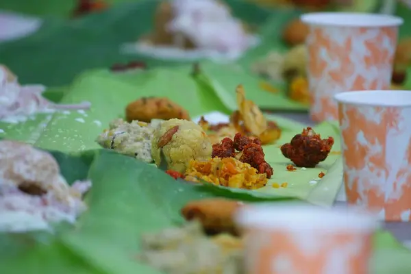 Close-up of banana-leaf meals served to guests