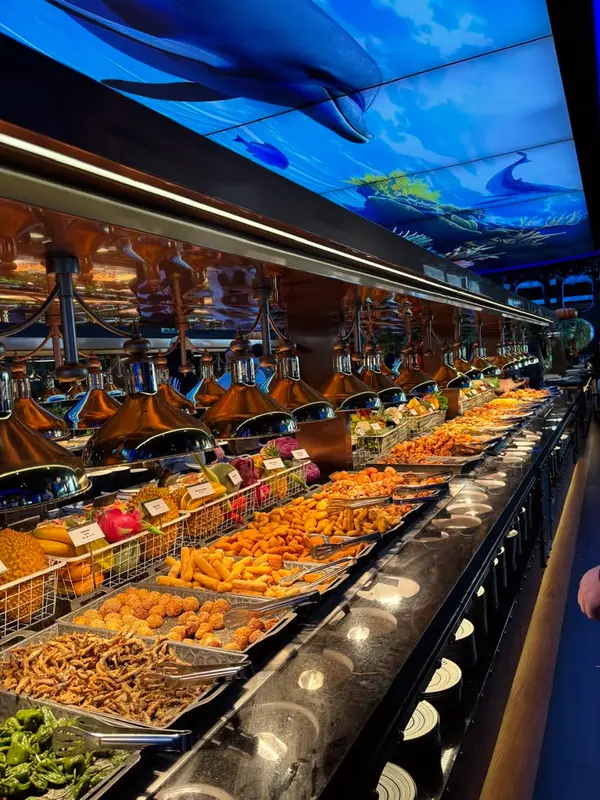 Long illuminated buffet counter lined with dishes