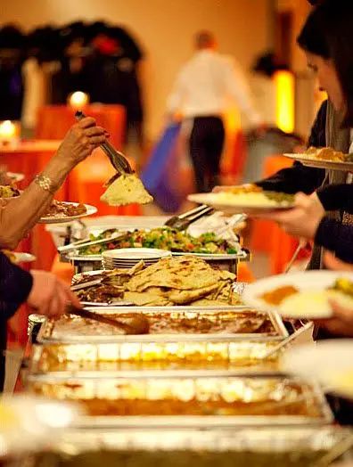 Guests helping themselves at a busy buffet